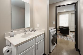 A bathroom with a sink and a washer and dryer